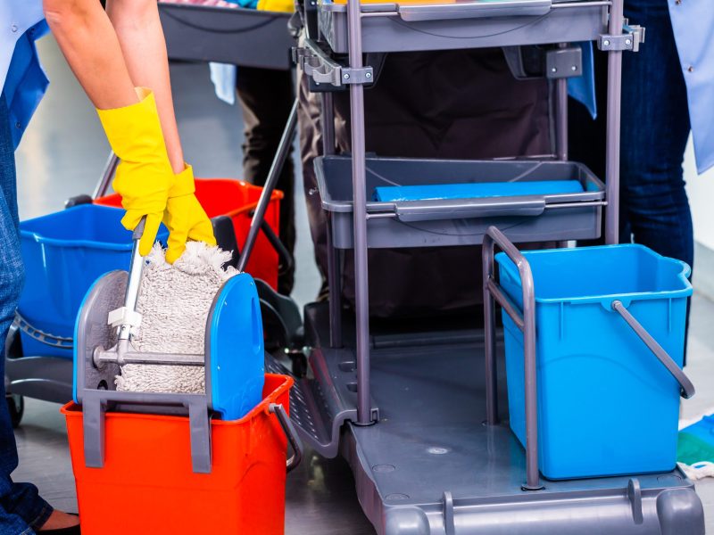 Cleaning ladies mopping floor, close up on hands and tools