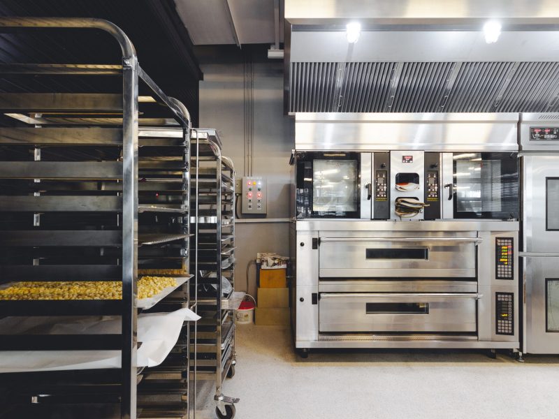 modern-pastry-kitchen-decorated-black-white-steel-with-baking-machine